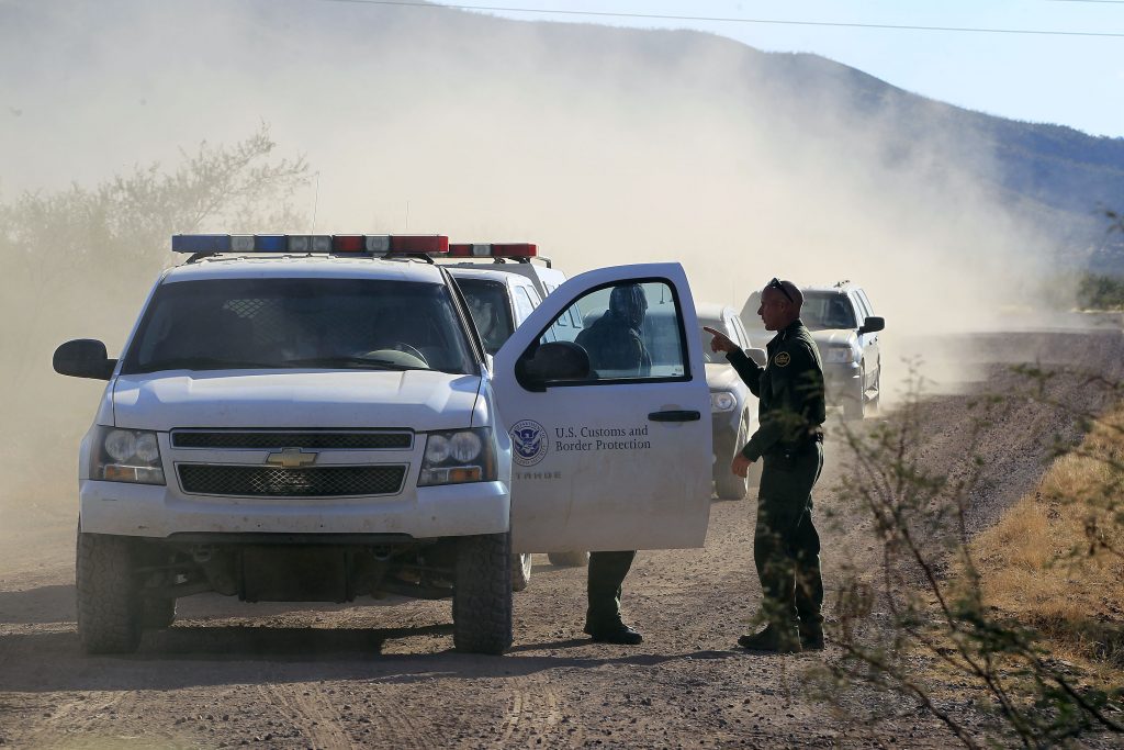 FILE - In this Oct. 2, 1012 file photo, U.S. Customs and Border Protection officers and other law enforcement jurisdictions drive the roads near near Bisbee, Ariz. New Homeland Security Secretary Jeh Johnson is reviewing the departments use of force policies, a Homeland Security official said Friday. The official said Johnson has been reviewing the rules about when agents along the border can use their guns since he took office in December. (AP Photo/Ross D. Franklin, file)